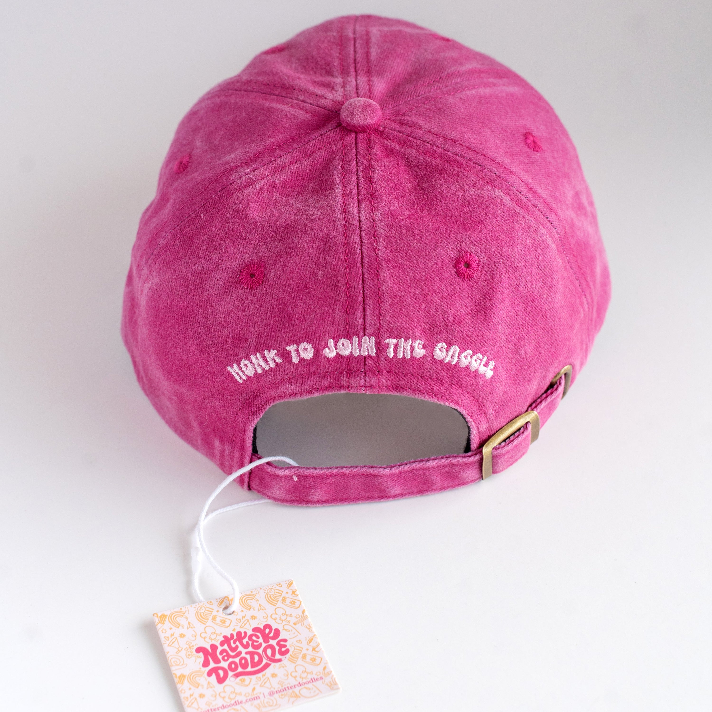 Pink cap with text on a white background