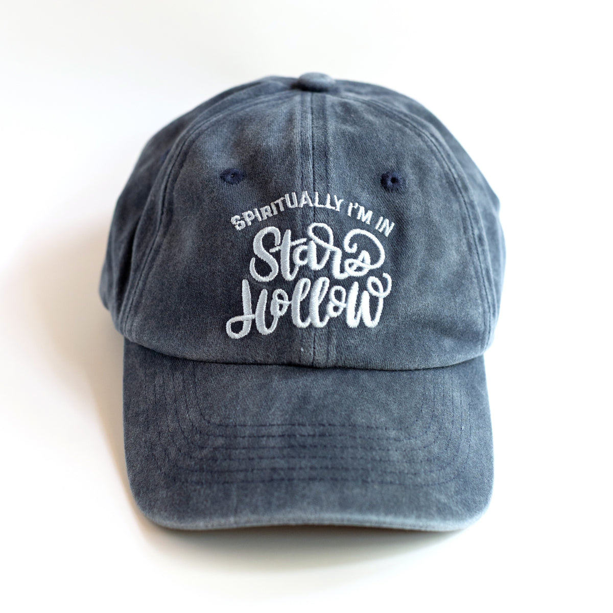 Spiritually I'm in Stars Hollow washed slate-blue dad cap with white embroidered lettering, front view