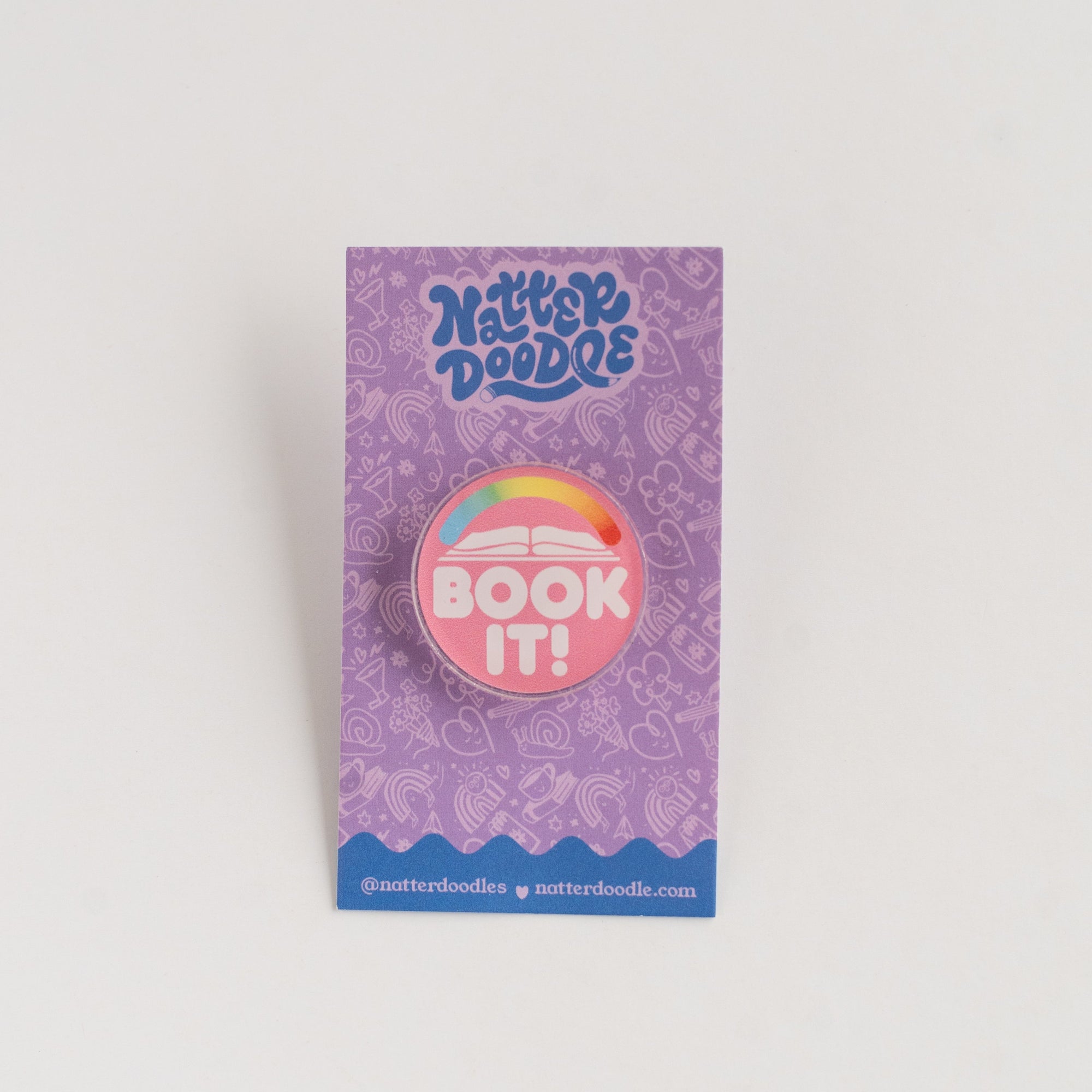 NatterDoodle button badge with 'Book It!' text on a purple card against a white background