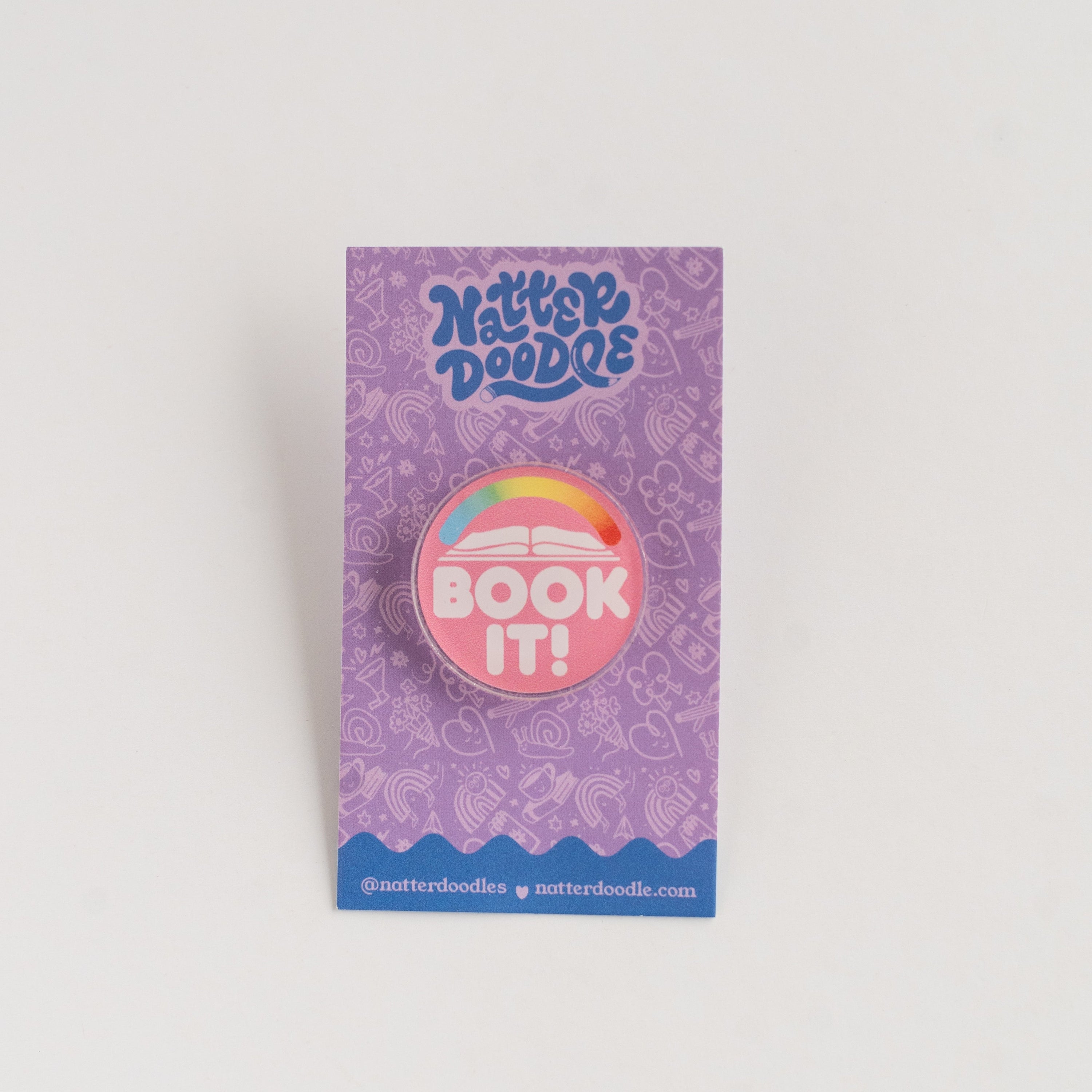 NatterDoodle button badge with 'Book It!' text on a purple card against a white background