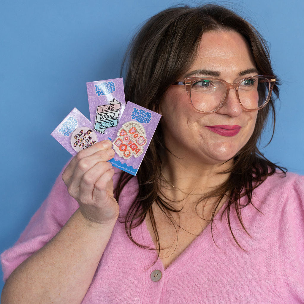 Woman holding colorful cards against a blue background