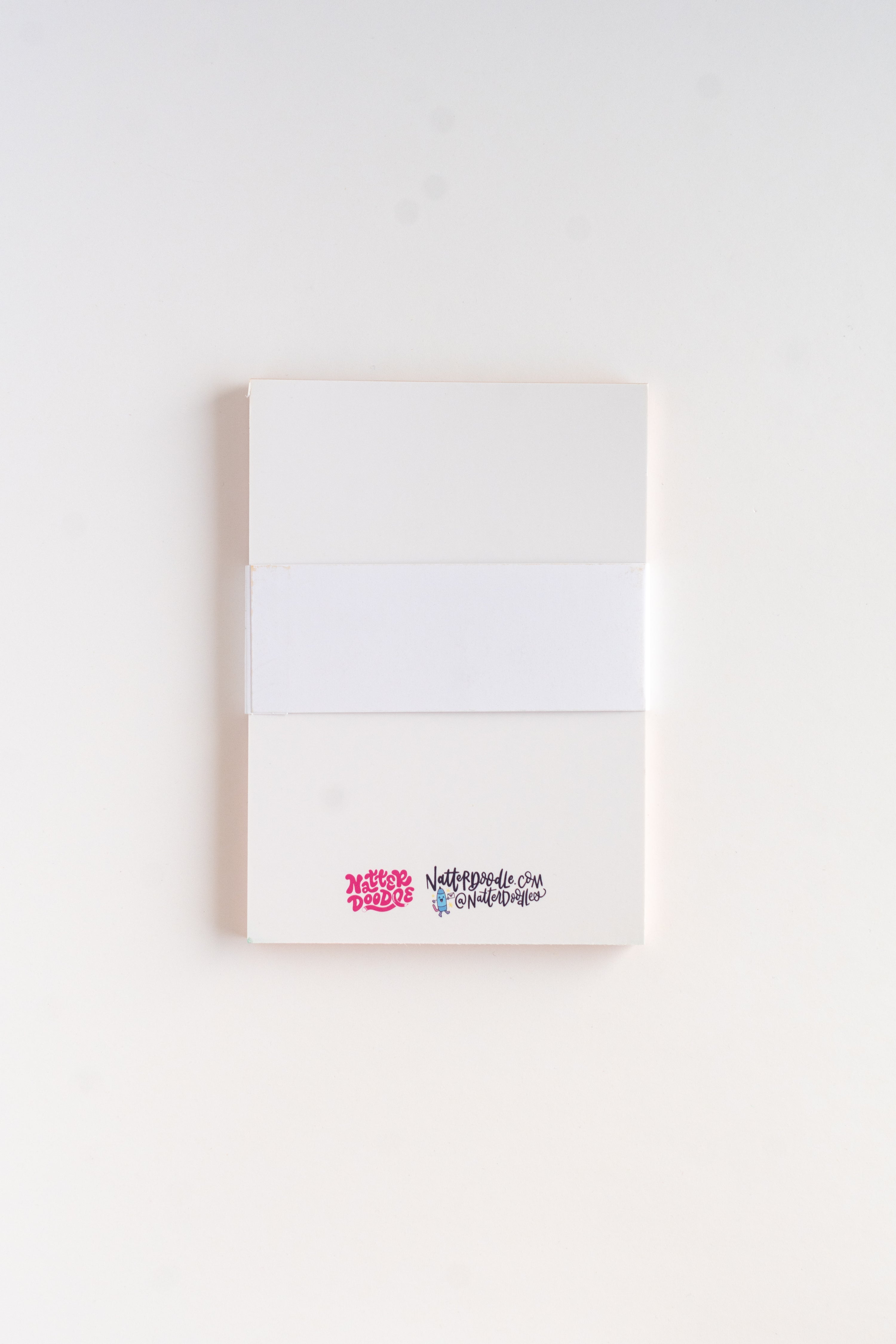White notebook with colorful text on a white background
