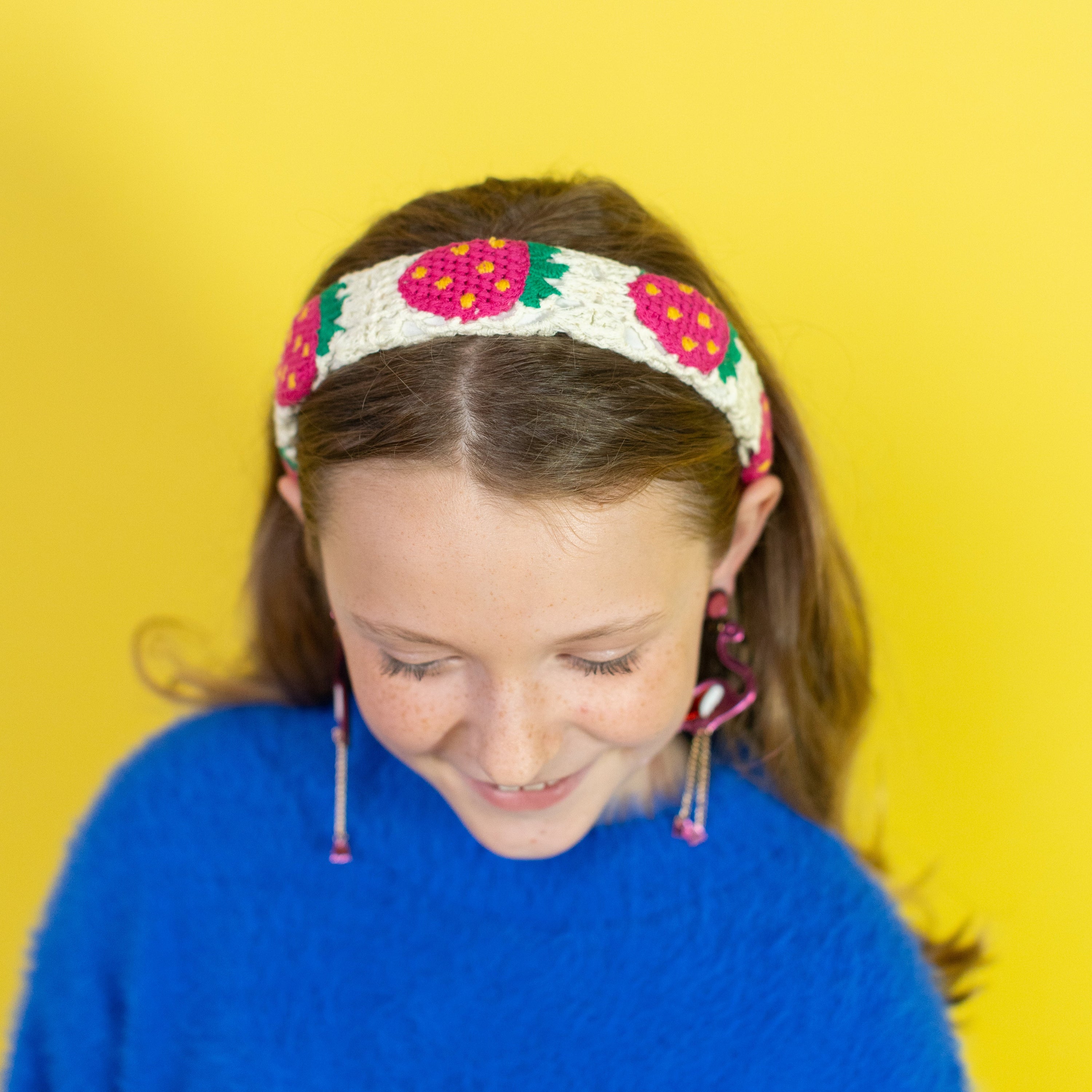 Woman wearing a colorful headband with a yellow background