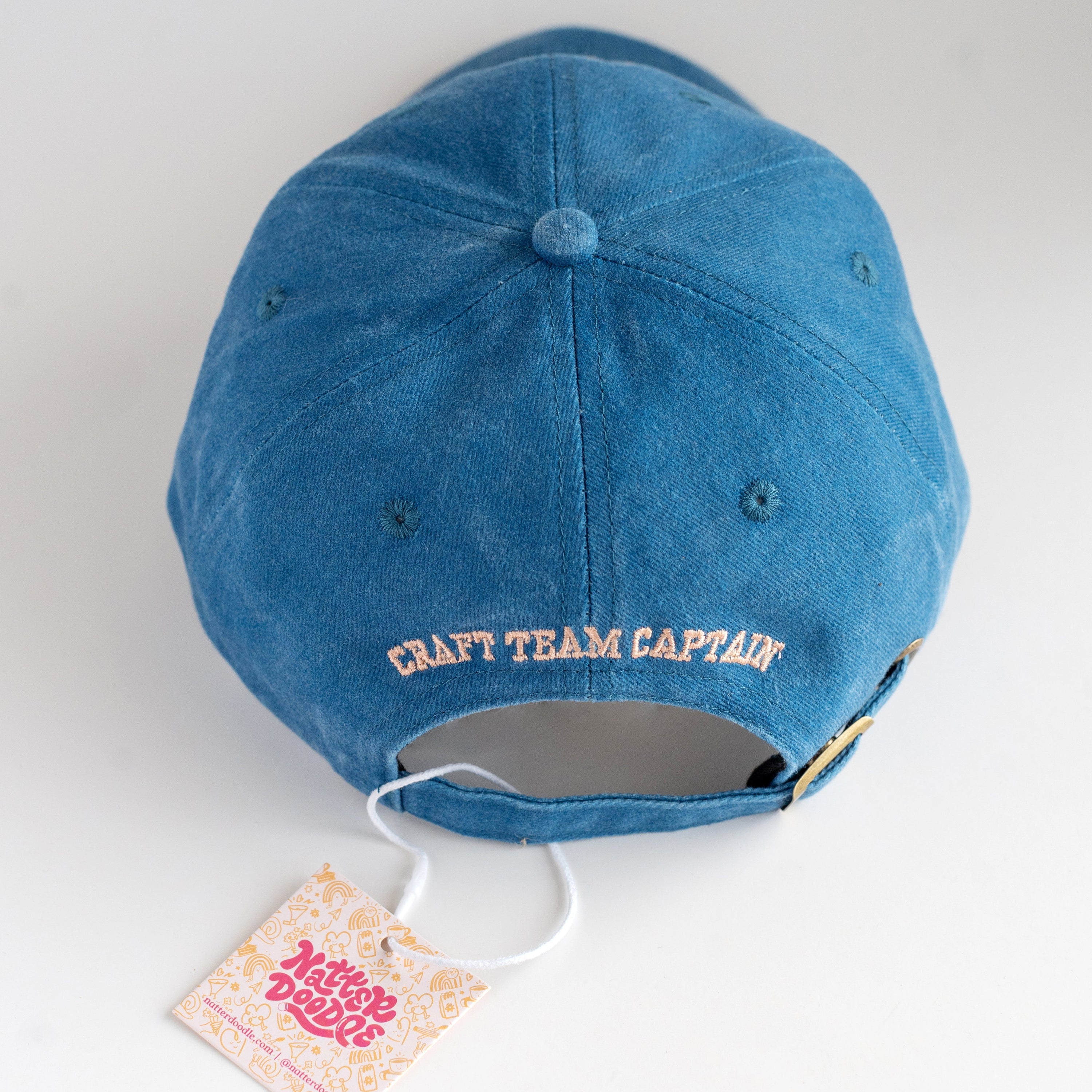Blue cap with 'Craft Team Captain' text on a white background