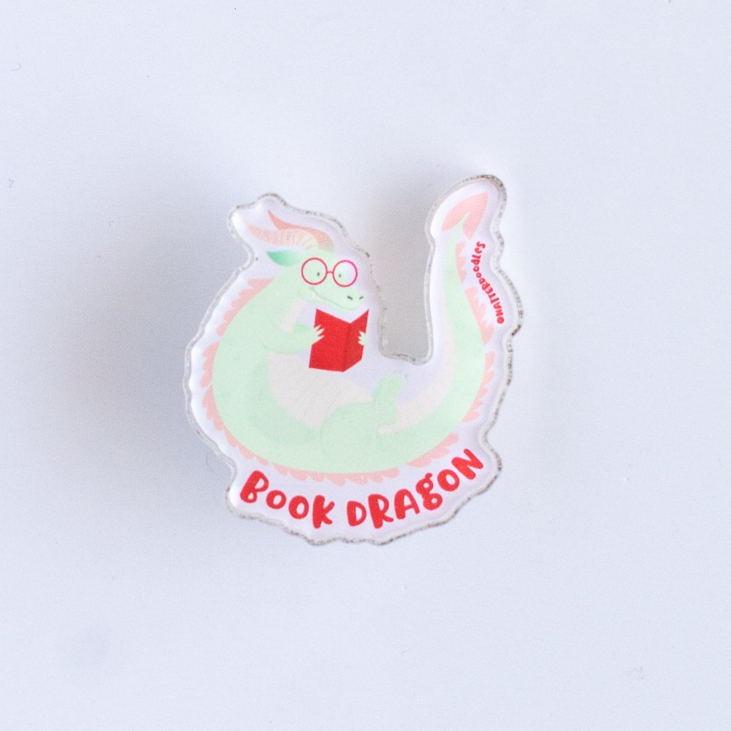 Pin with a cartoonish design on a light purple background