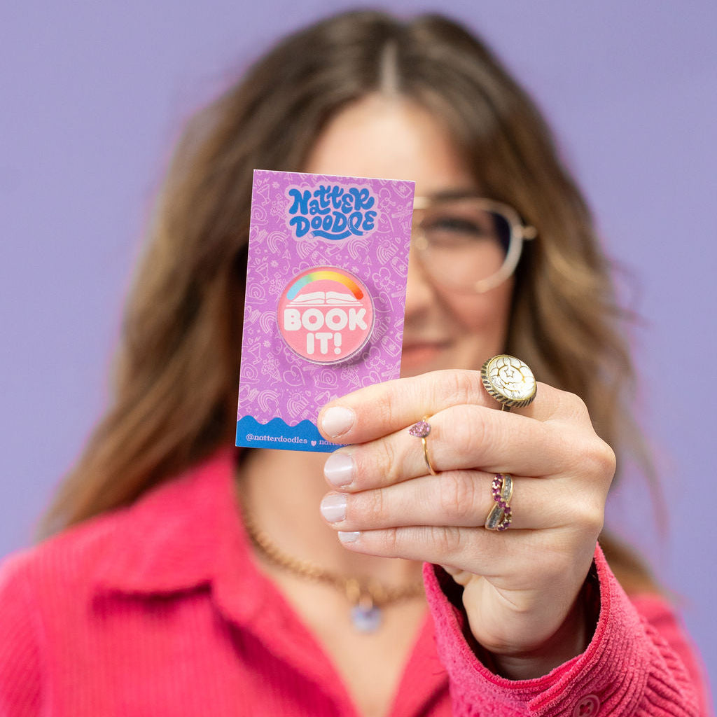 Woman holding a purple packaging with text against a purple background