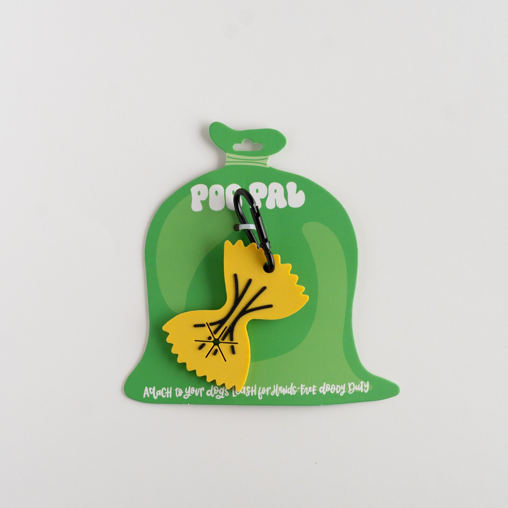 Yellow noodle accessory with a black handle on a green packaging label against a white background