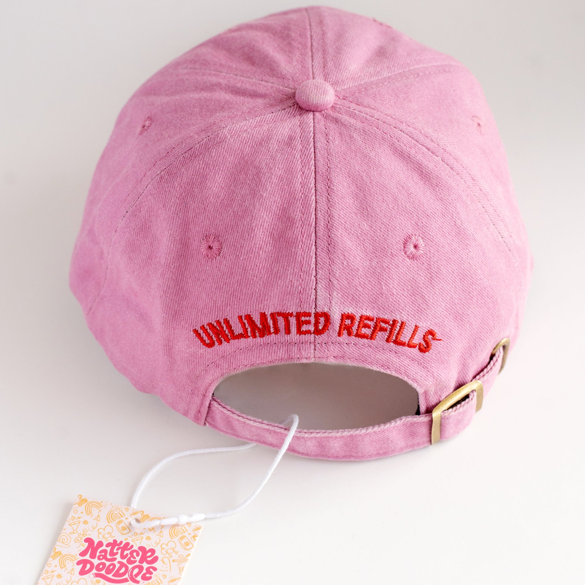 Pink cap with 'Unlimited Refills' text on a white background