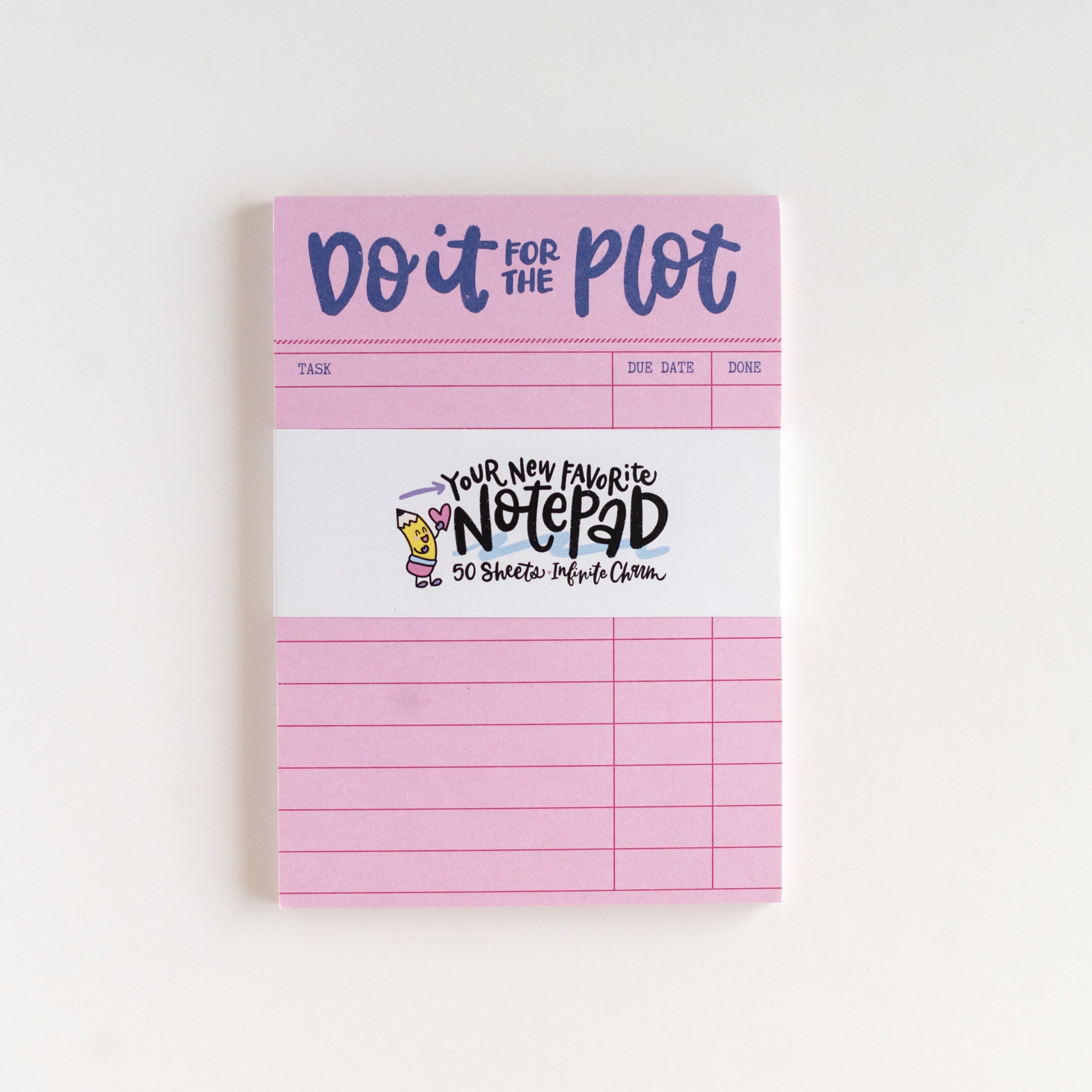 Pink notepad with text on a white background