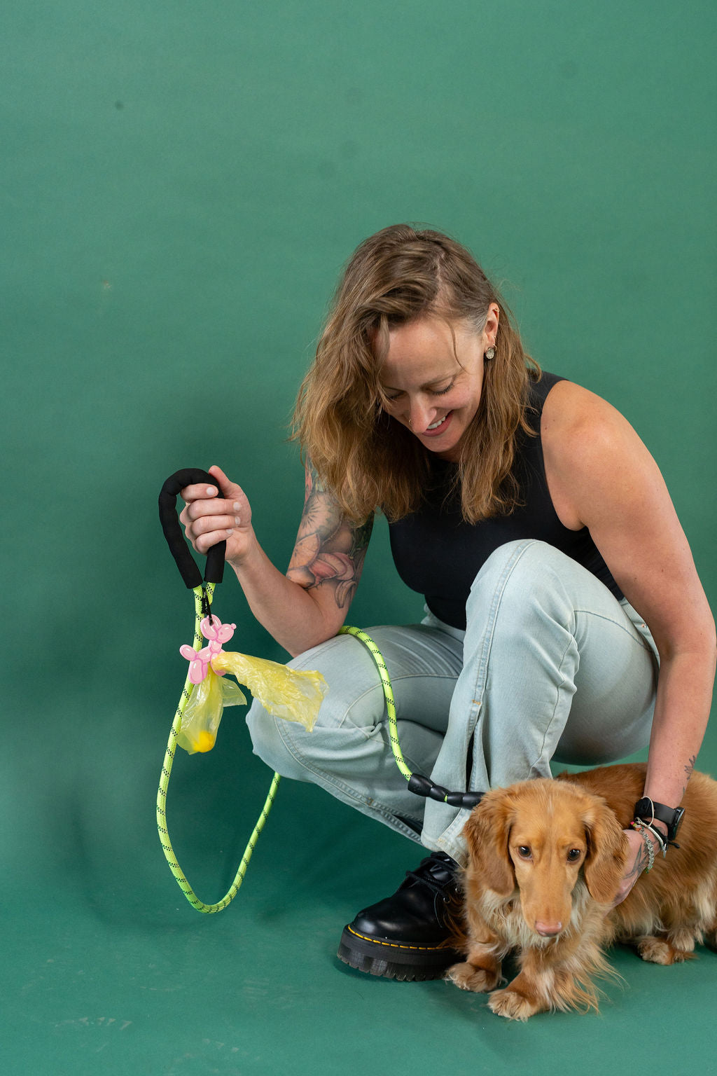Woman with a dog on a green background