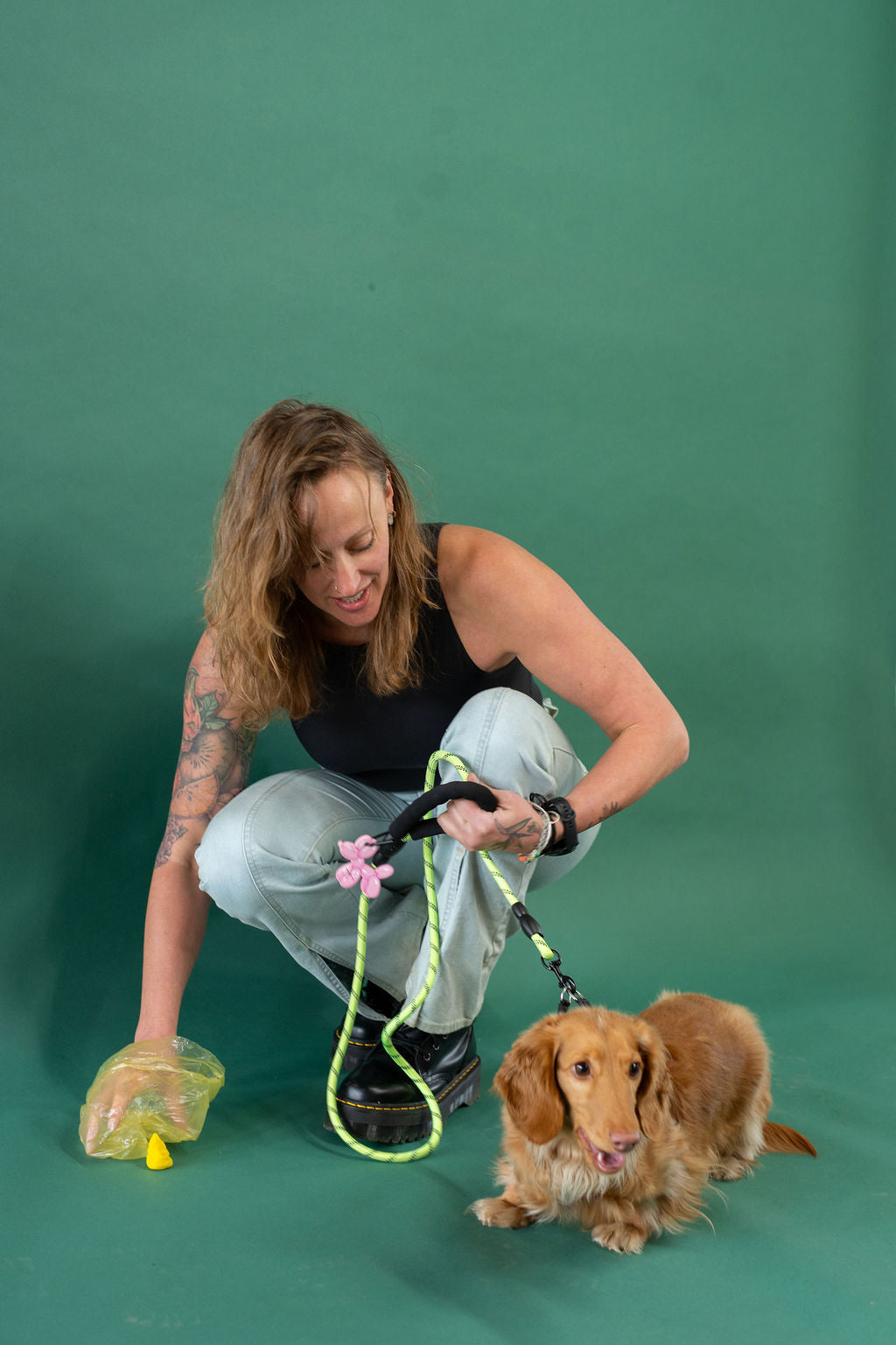 Woman with a dog on a green background