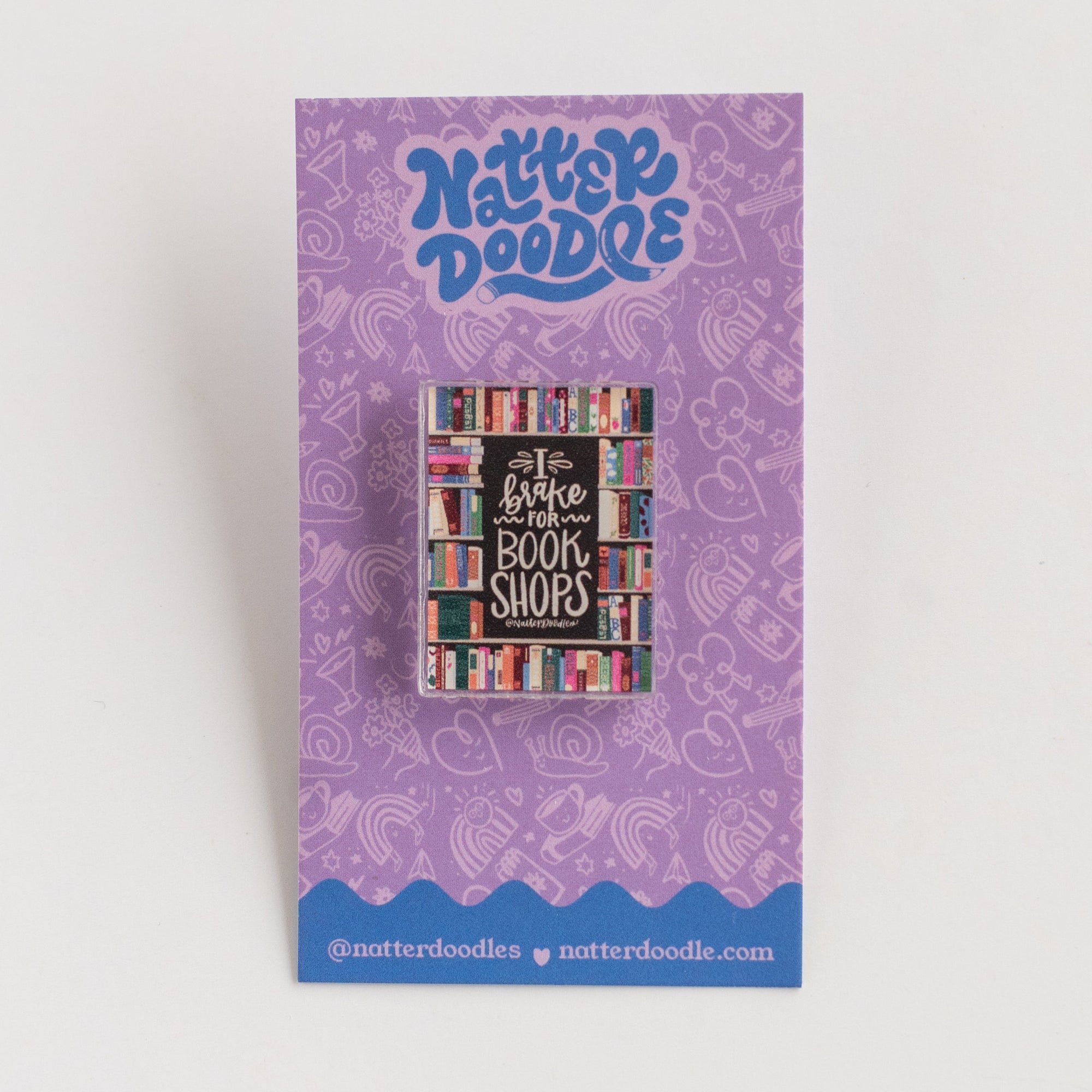 Purple card backer with pin with colorful text and design on a white background