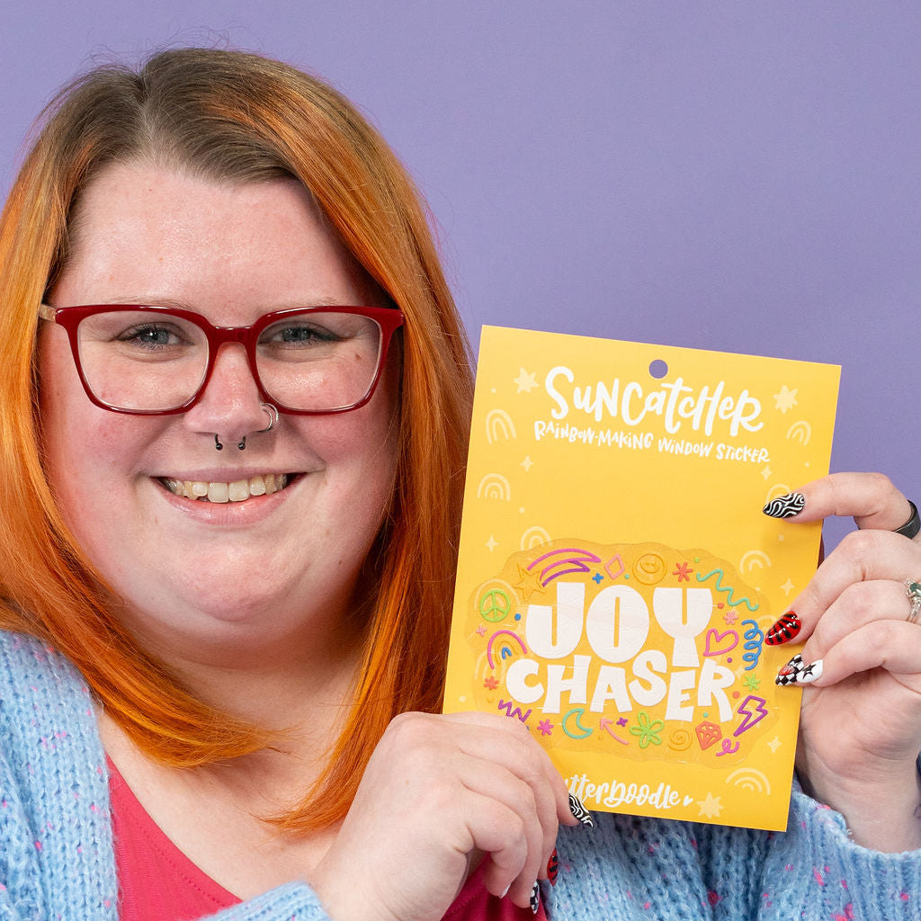 Person holding a yellow product packaging with text against a purple background