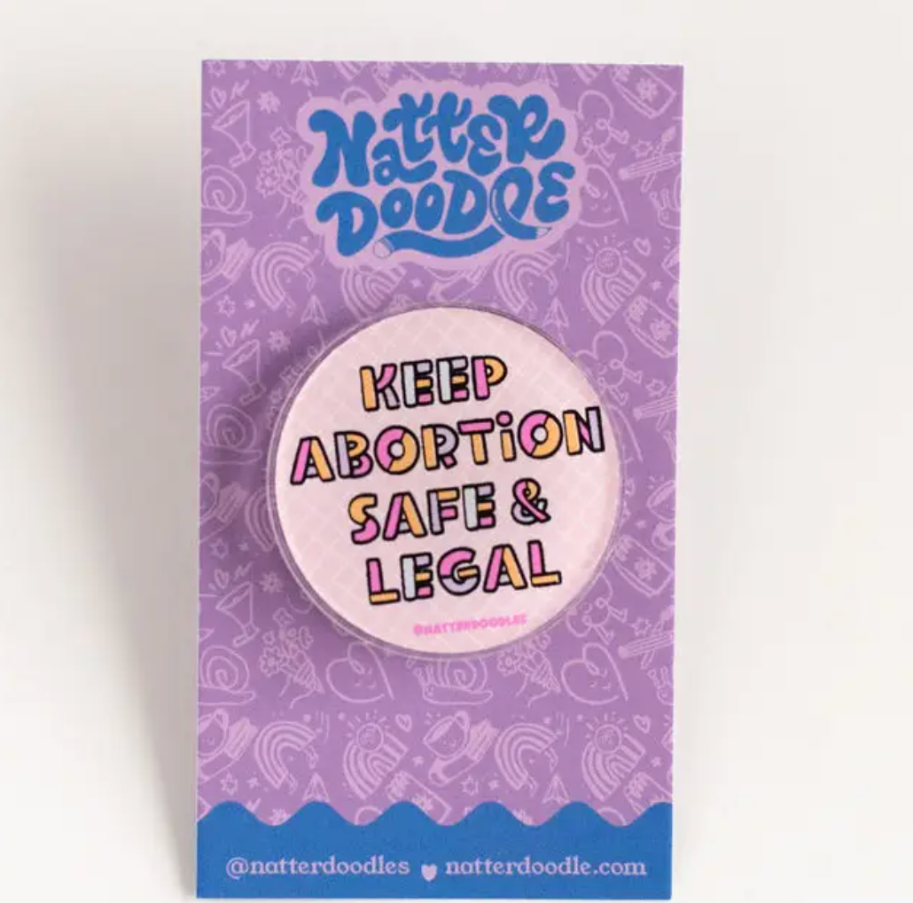 Button with 'Keep Abortion Safe & Legal' text on a purple Natterdoodle branded card.