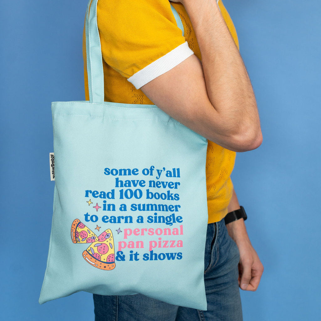 personal pan pizza themed blue tgote bag man holding it on blue background