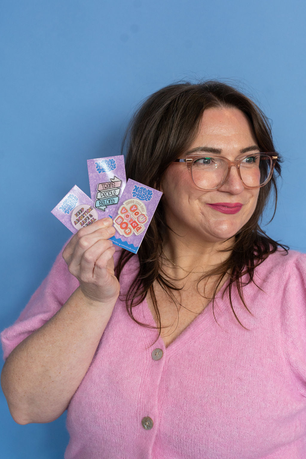 Woman holding colorful cards against a blue background
