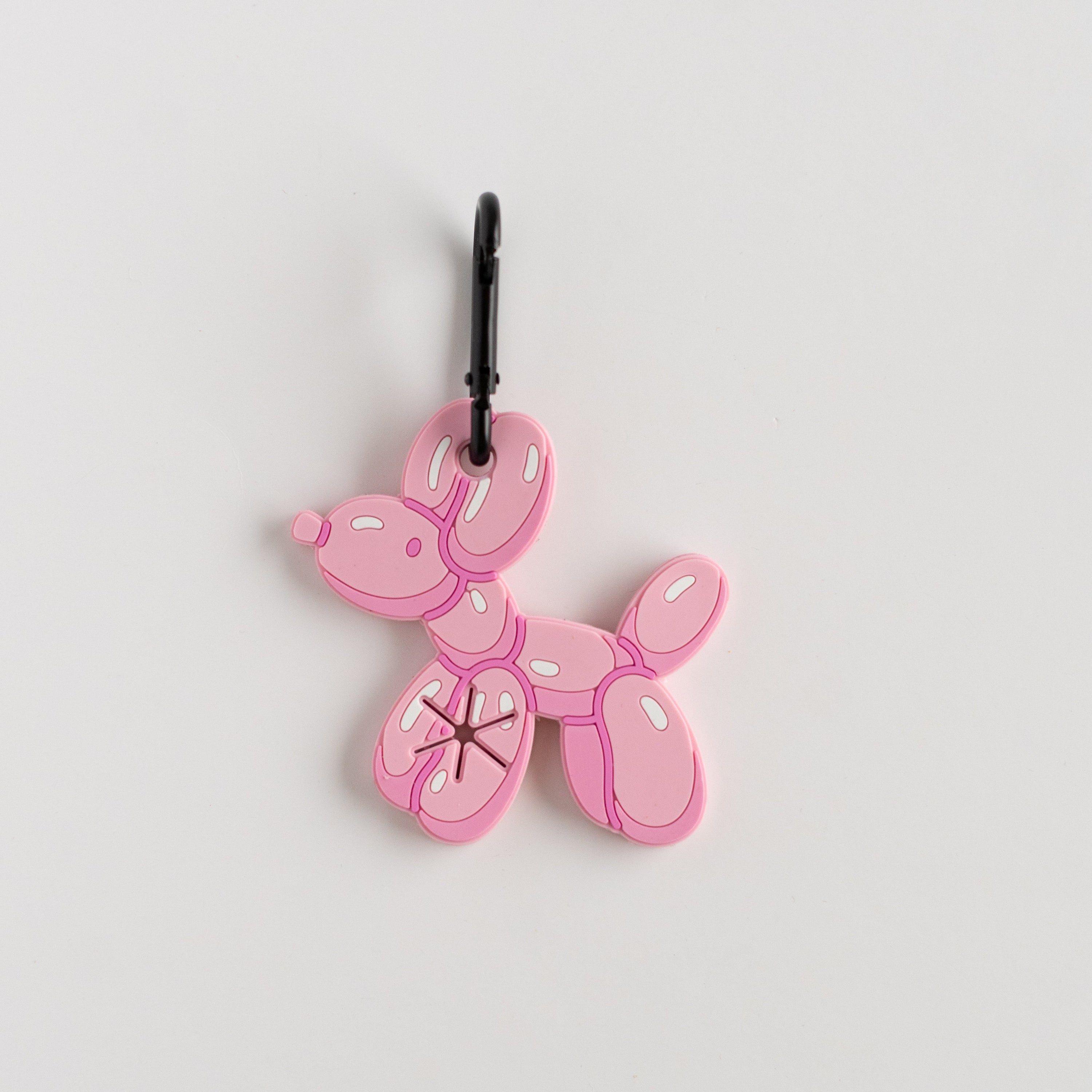 Pink balloon dog charm on a white background