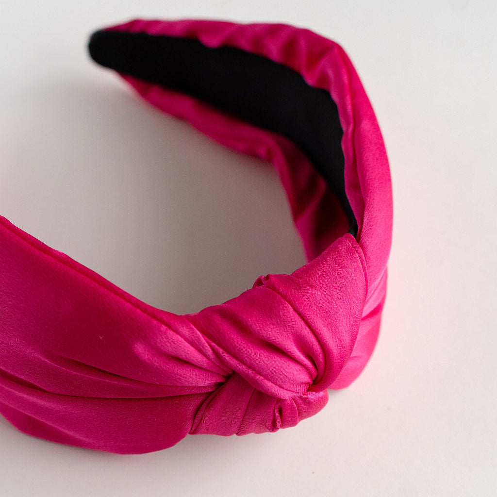 Pink headband with a knot on a white background