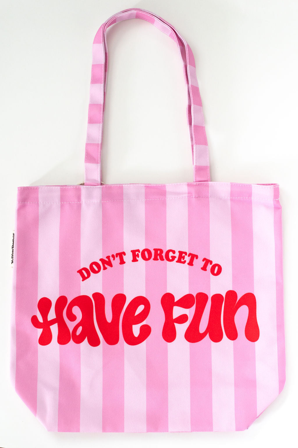 Pink and white striped tote bag with red text on a white background