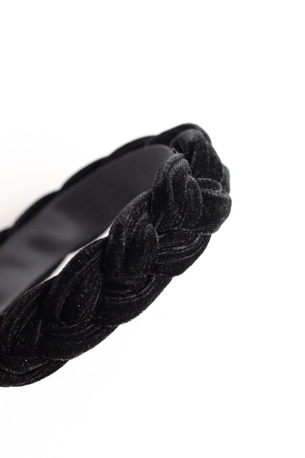 Black velvet headband with braided design on a white background