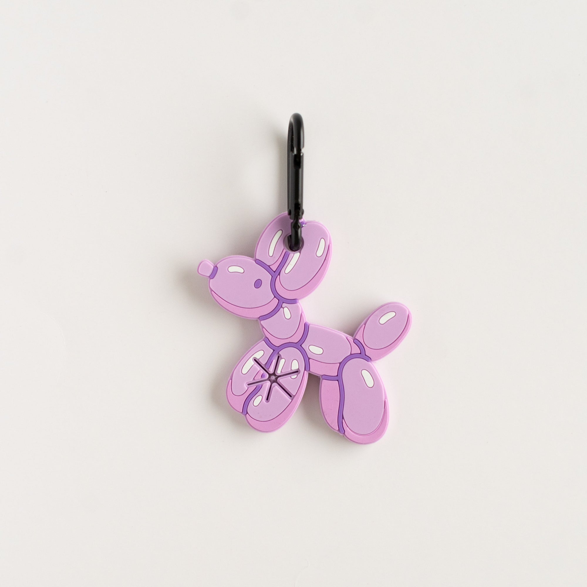 Purple balloon dog charm on a white background