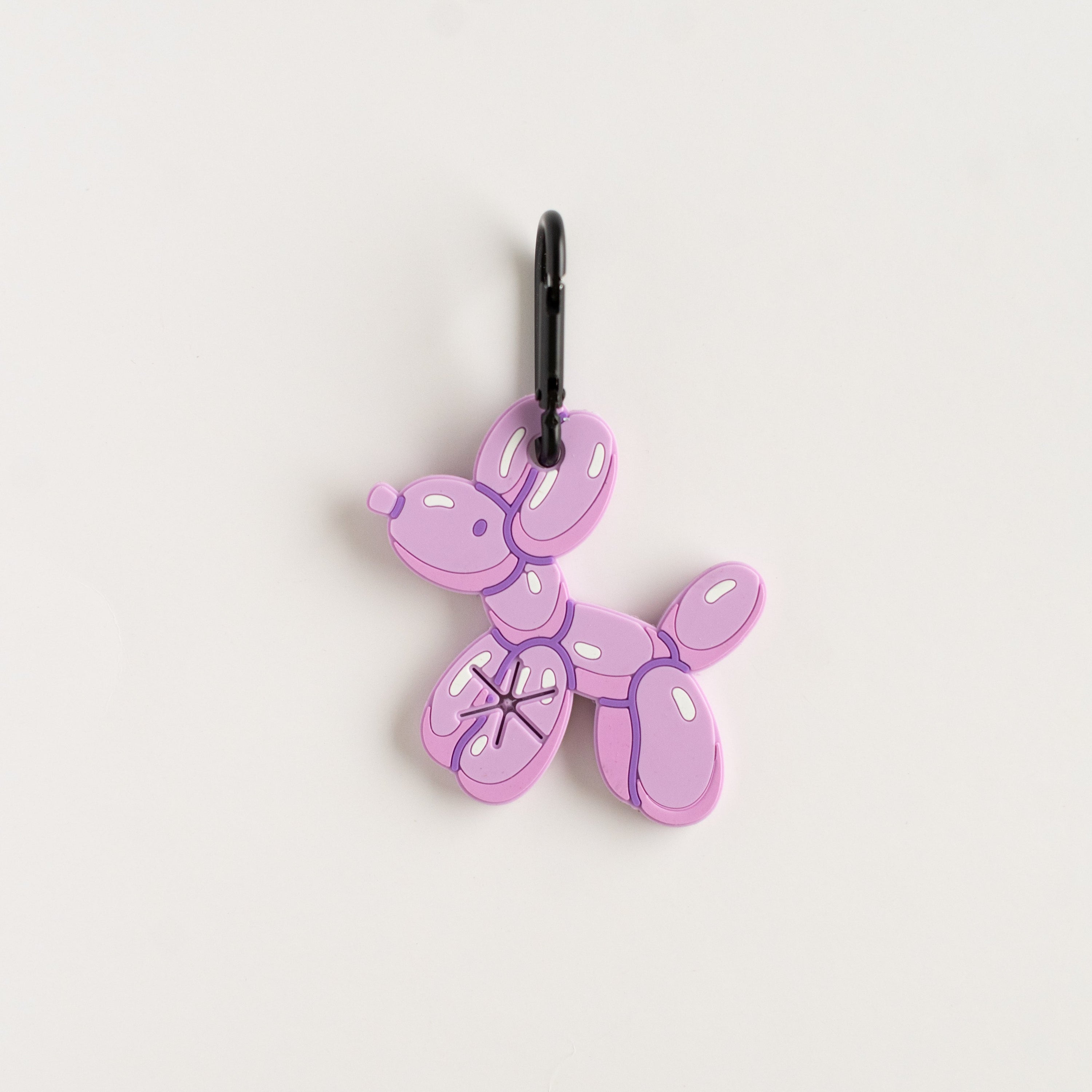 Purple balloon dog charm on a white background