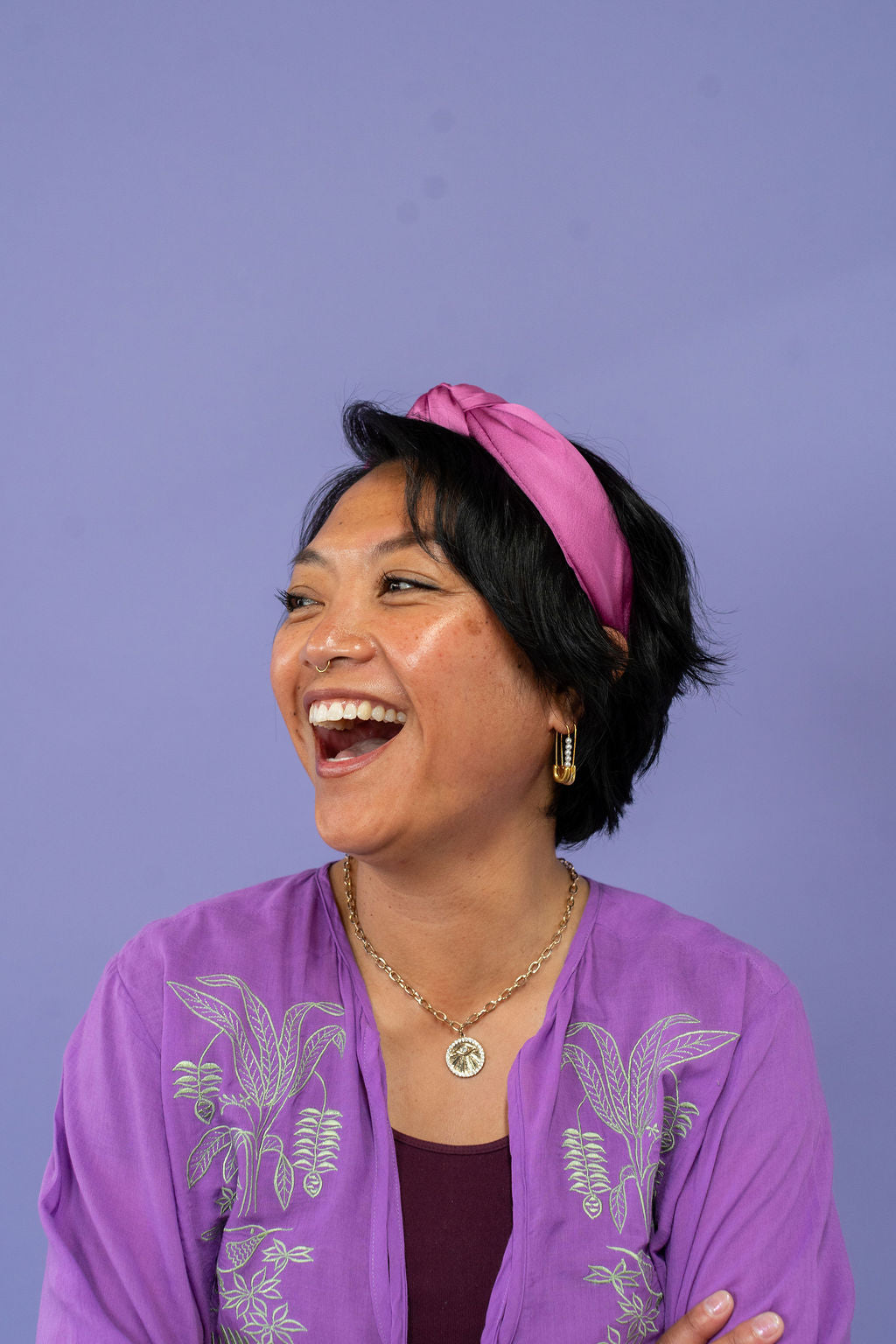gorgeous headband purple on woman wearing a purple shirt against a purple background