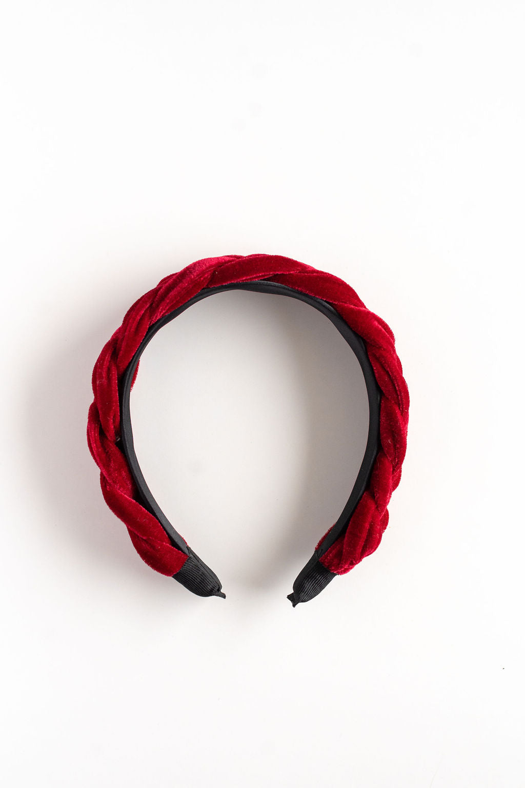 Red velvet headband with black accents on a white background
