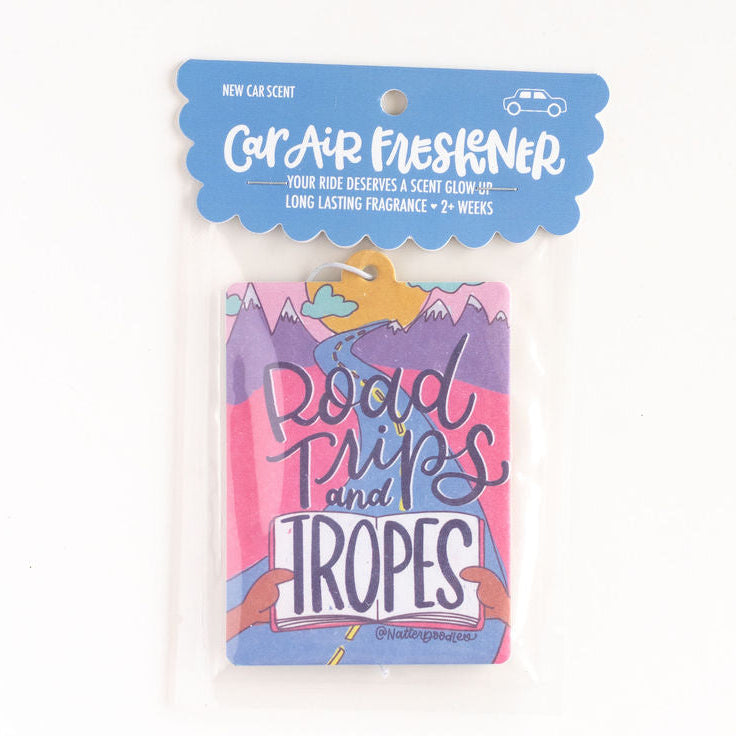 Car air freshener packaging with 'Road Trips and Tropes' text on a white background