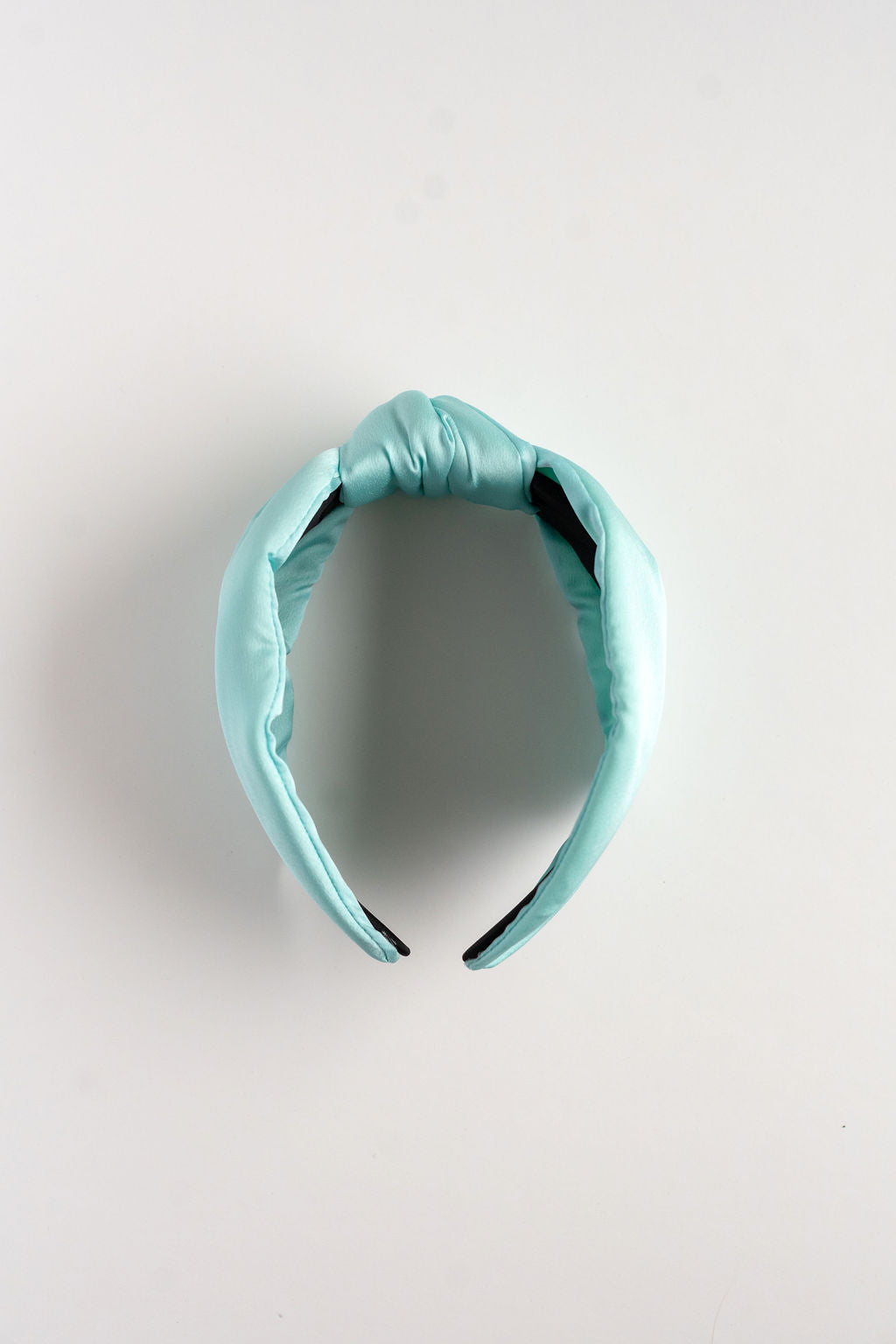 light blue headband on a light gray background