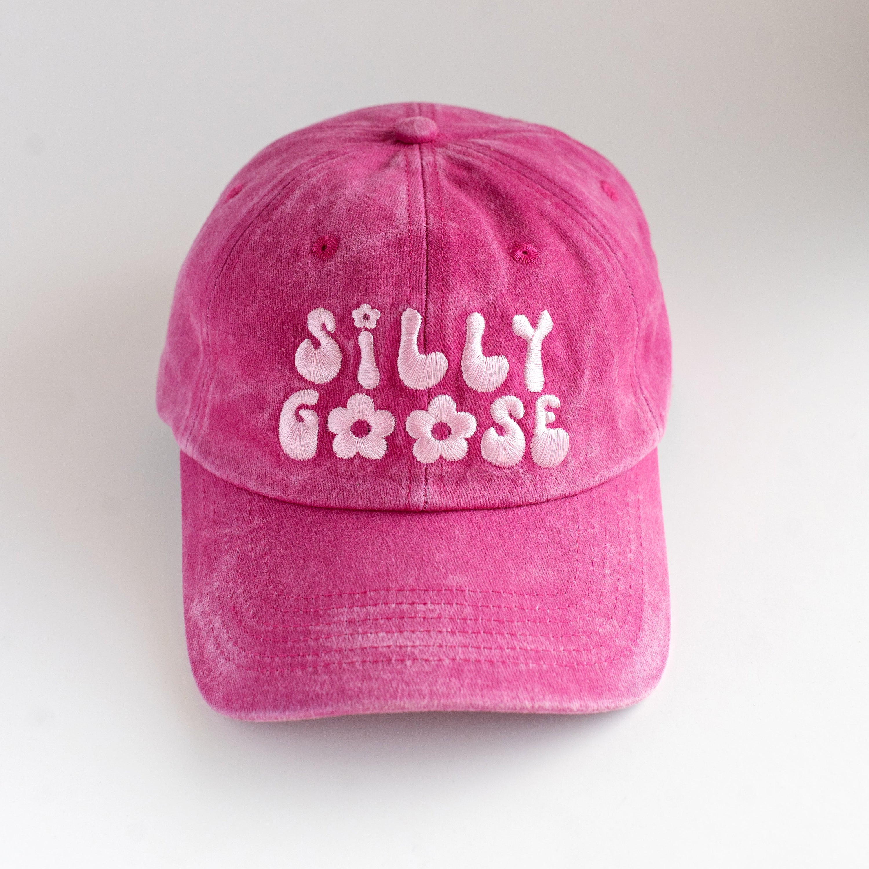 Pink cap with 'Silly Goose' text on a white background