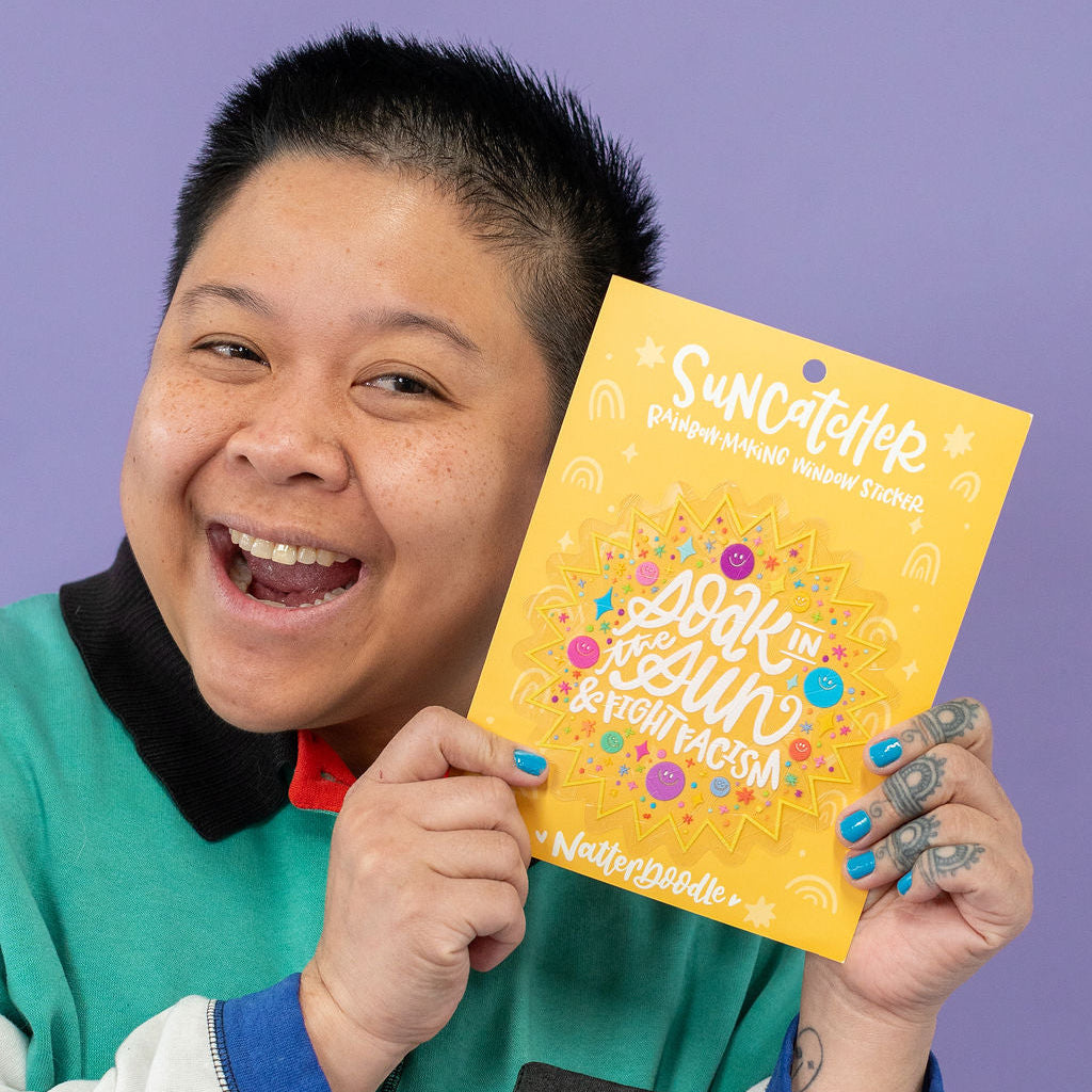 Person holding a yellow package against a purple background