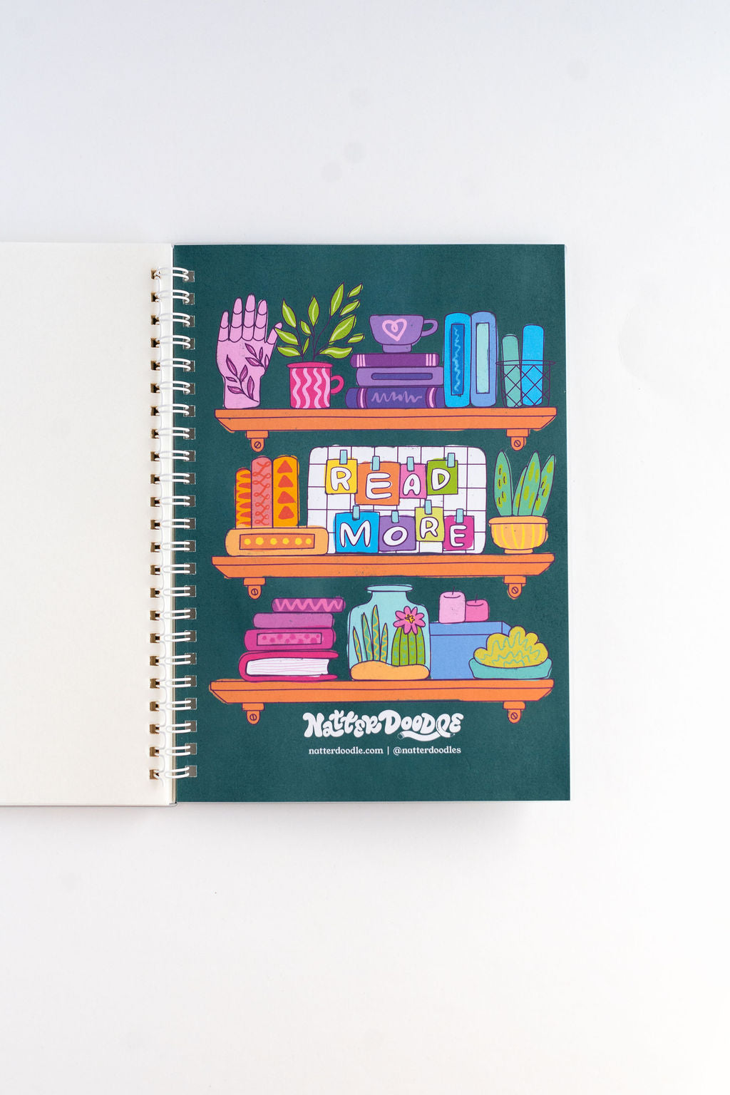 Notebook with colorful illustration of a bookshelf on a white background