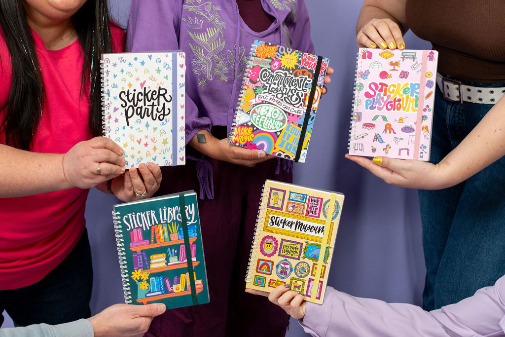People holding colorful sticker books with various designs and text.