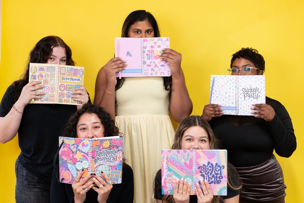 Five people holding up colorful sticker books against a yellow background
