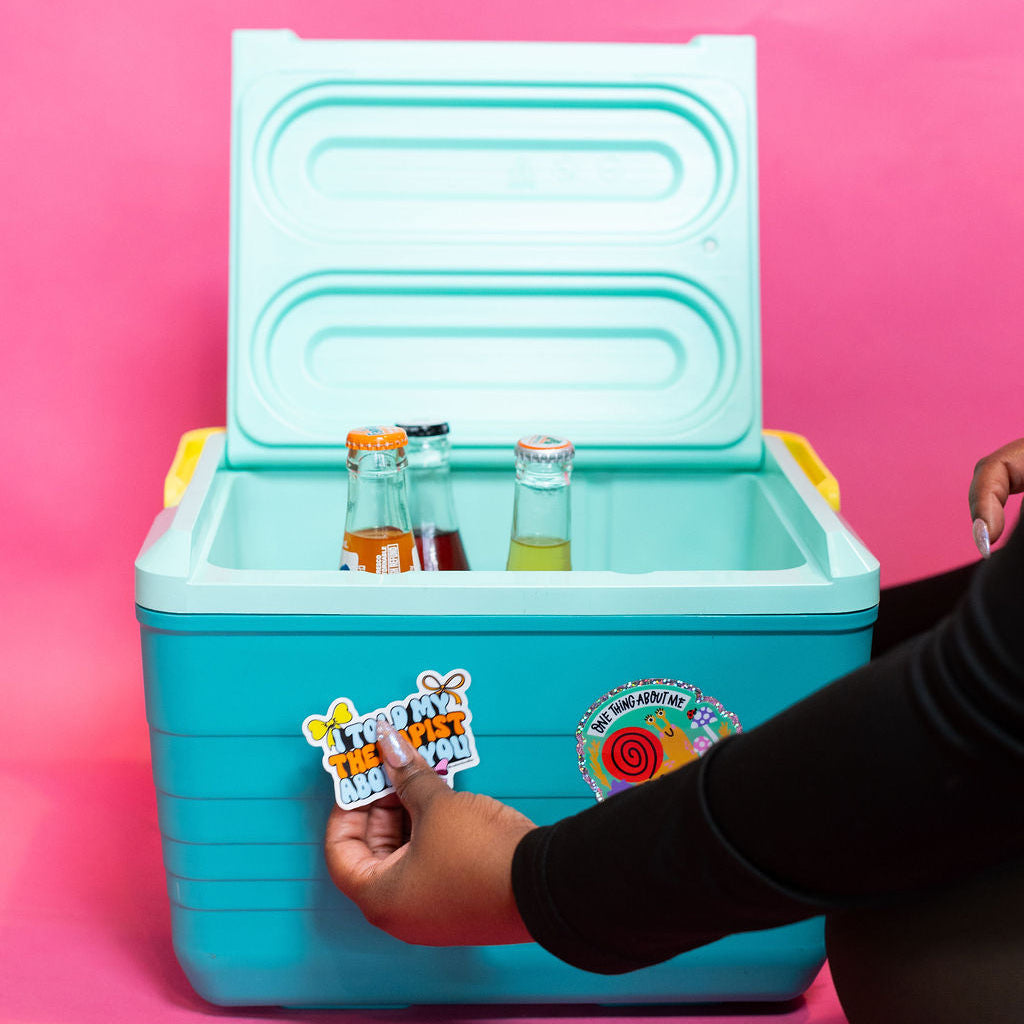 Turquoise cooler with drinks on a pink background