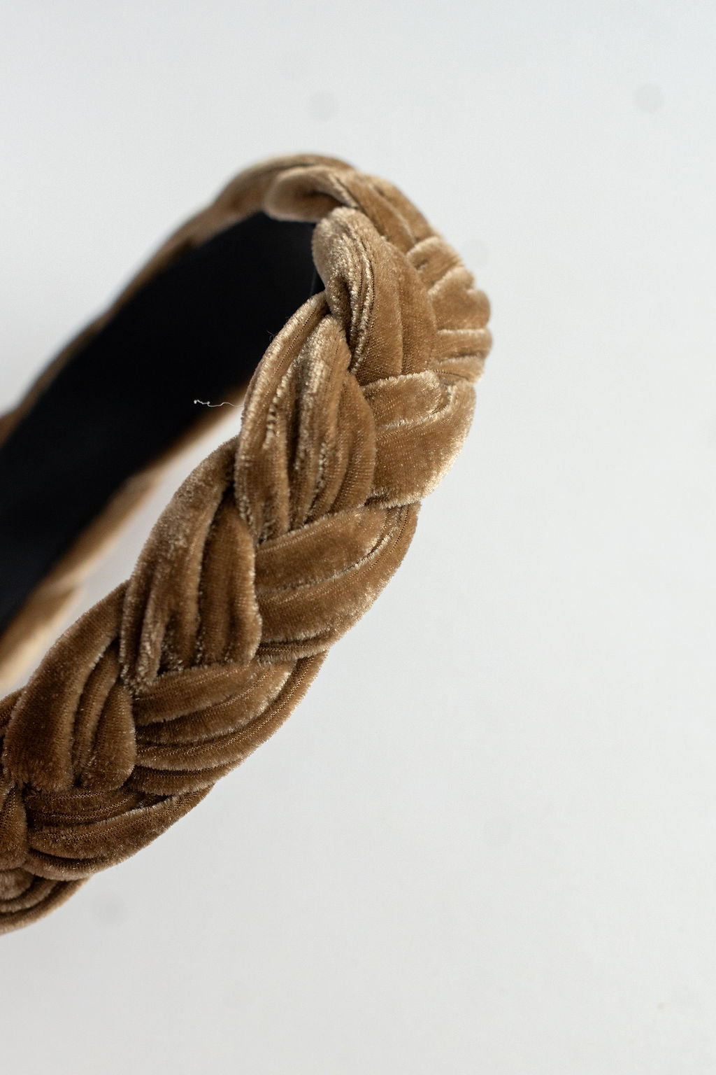 Brown woven headband on a white background