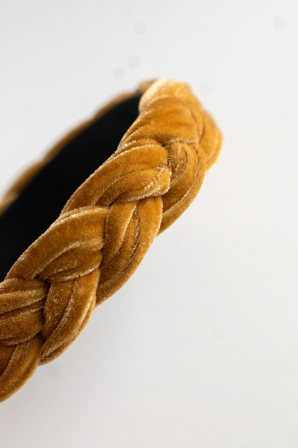 yellow braided headband on a white background