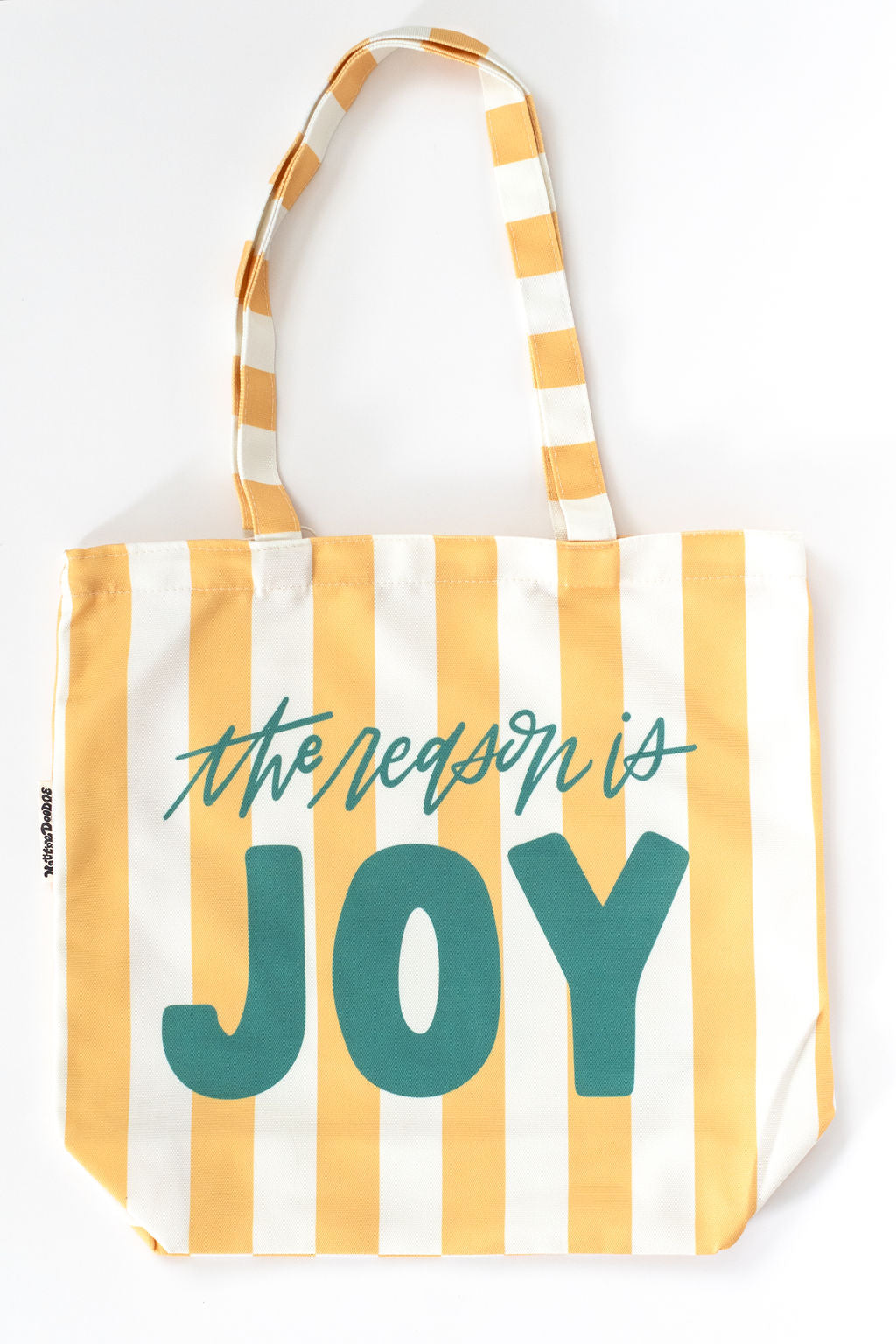 Tote bag with yellow and white stripes and 'the reason is JOY' text on a white background